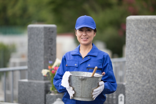 墓掃除する女性